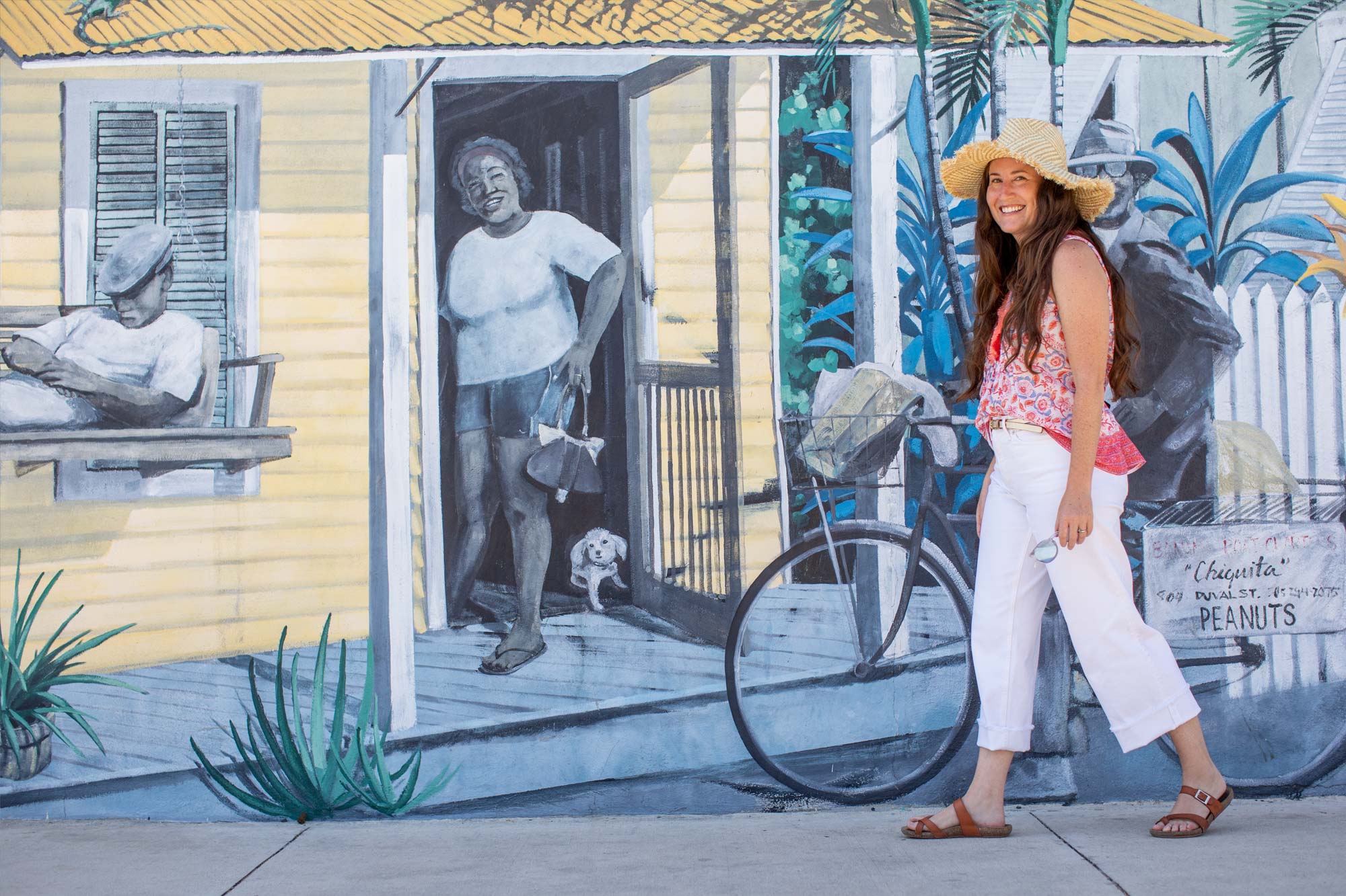 Analise Andrews walking in front of mural